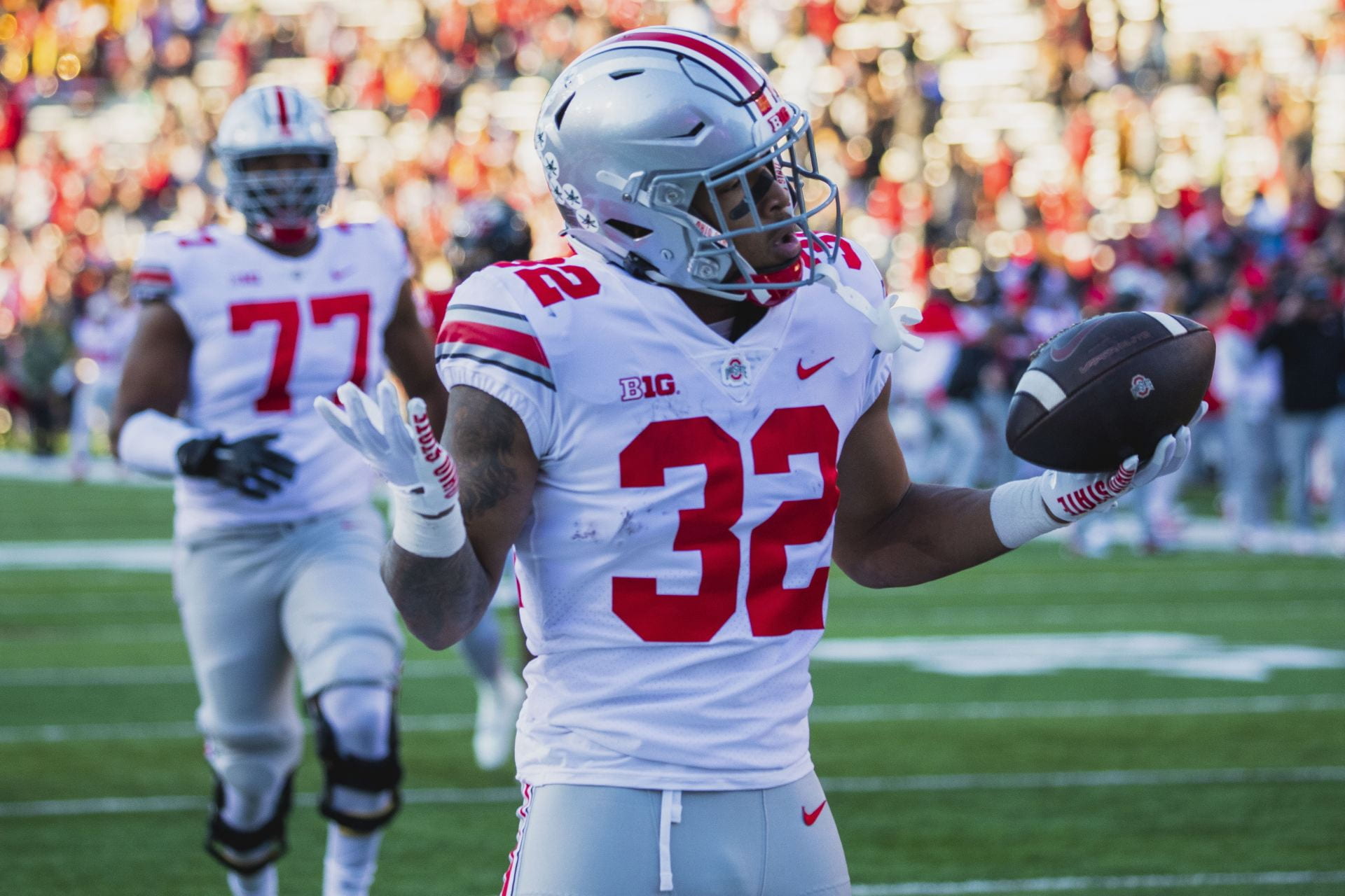 Ohio State football player with arms in shrug after touchdown